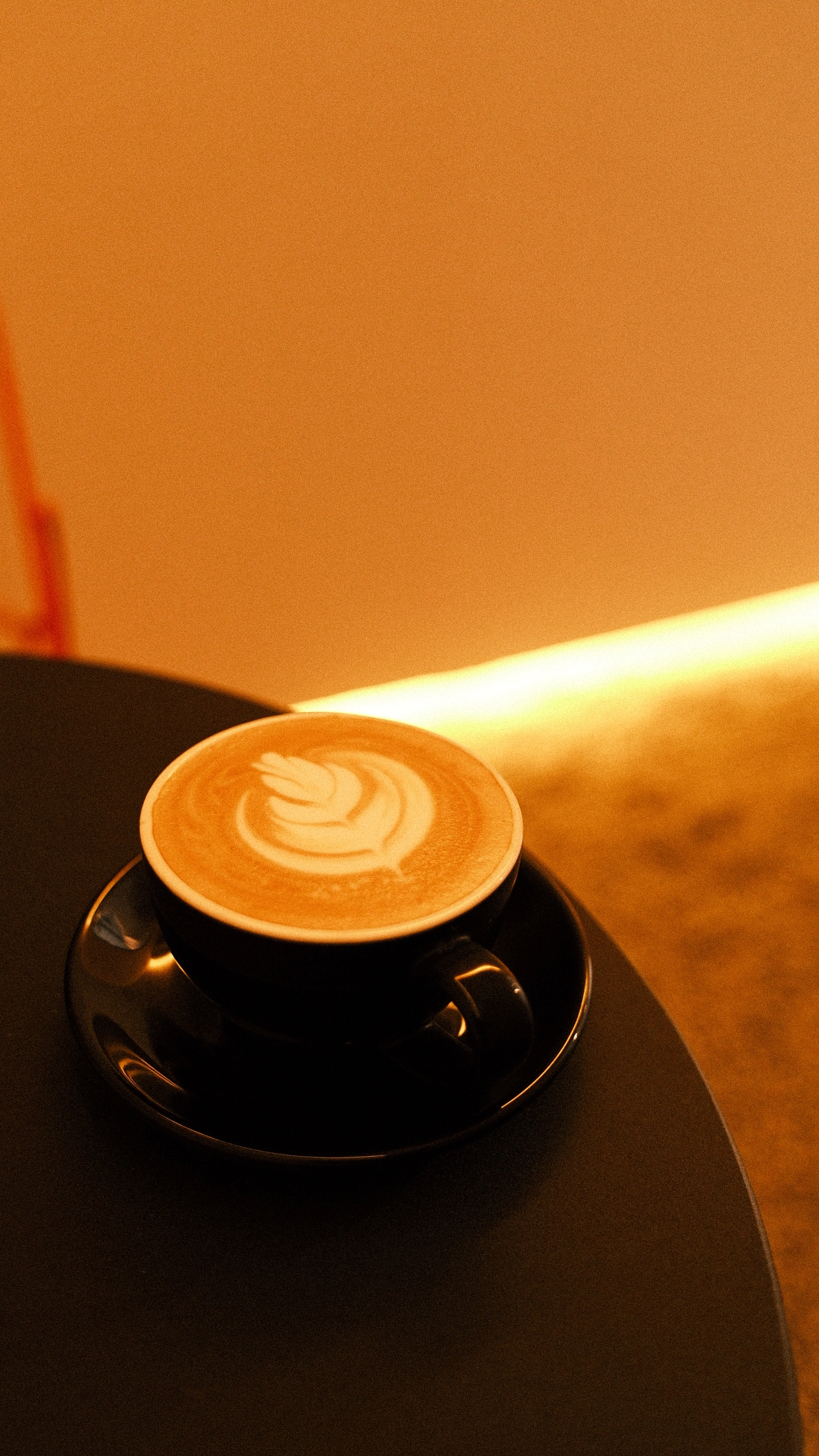 A flat white resting on a saucer